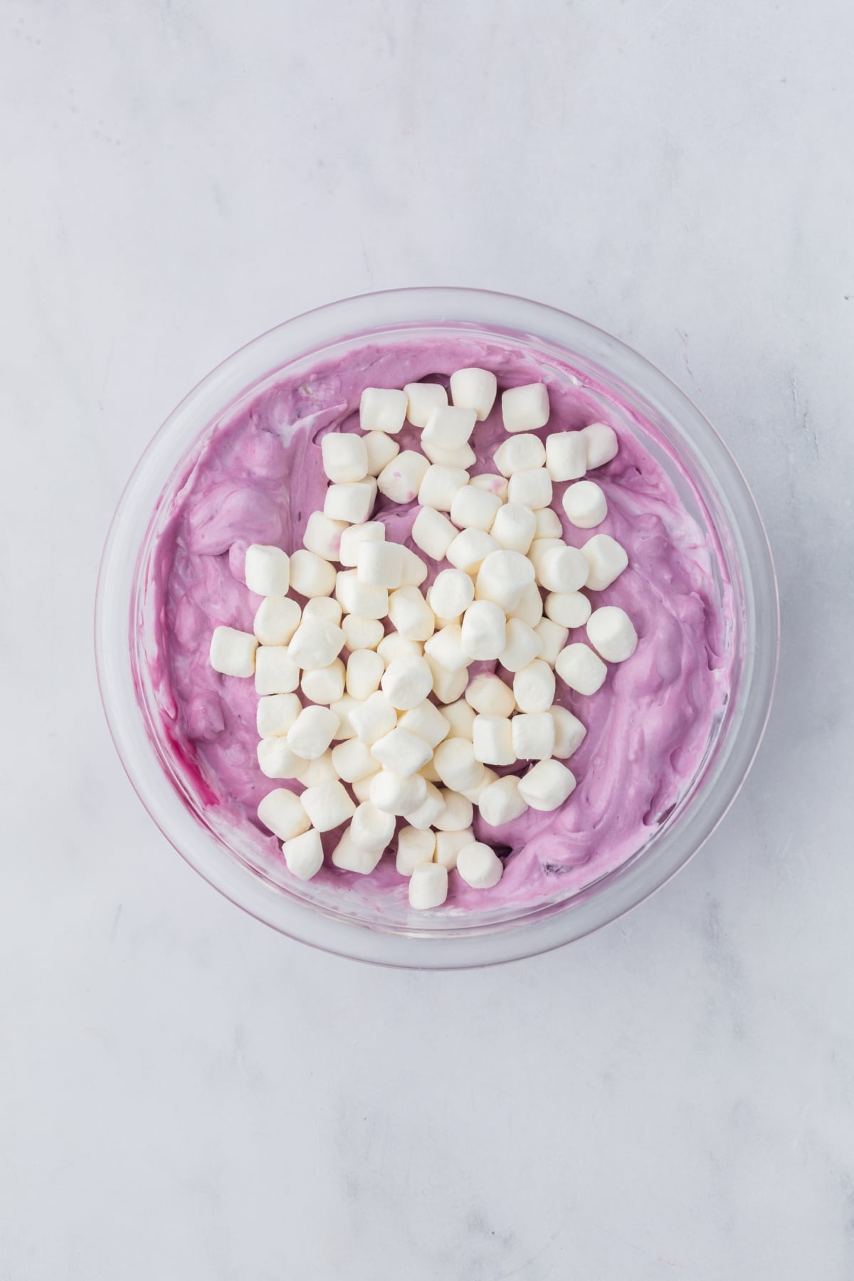 folding marshmallows into blueberry fluff mixture