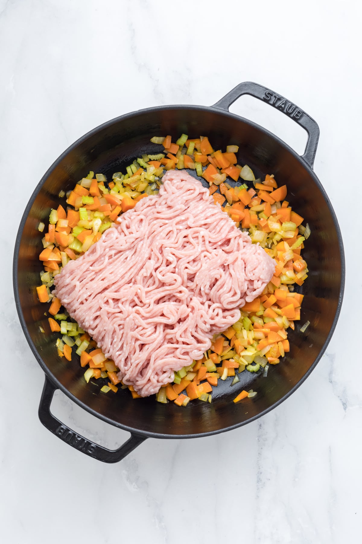 Carrots, celery, onions, and garlic, add the ground chicken in a skillet.