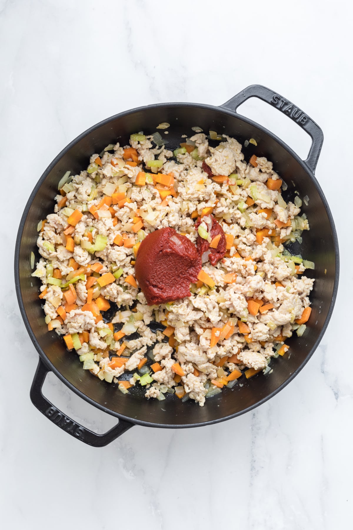 Tomato paste and wine added to the skillet.