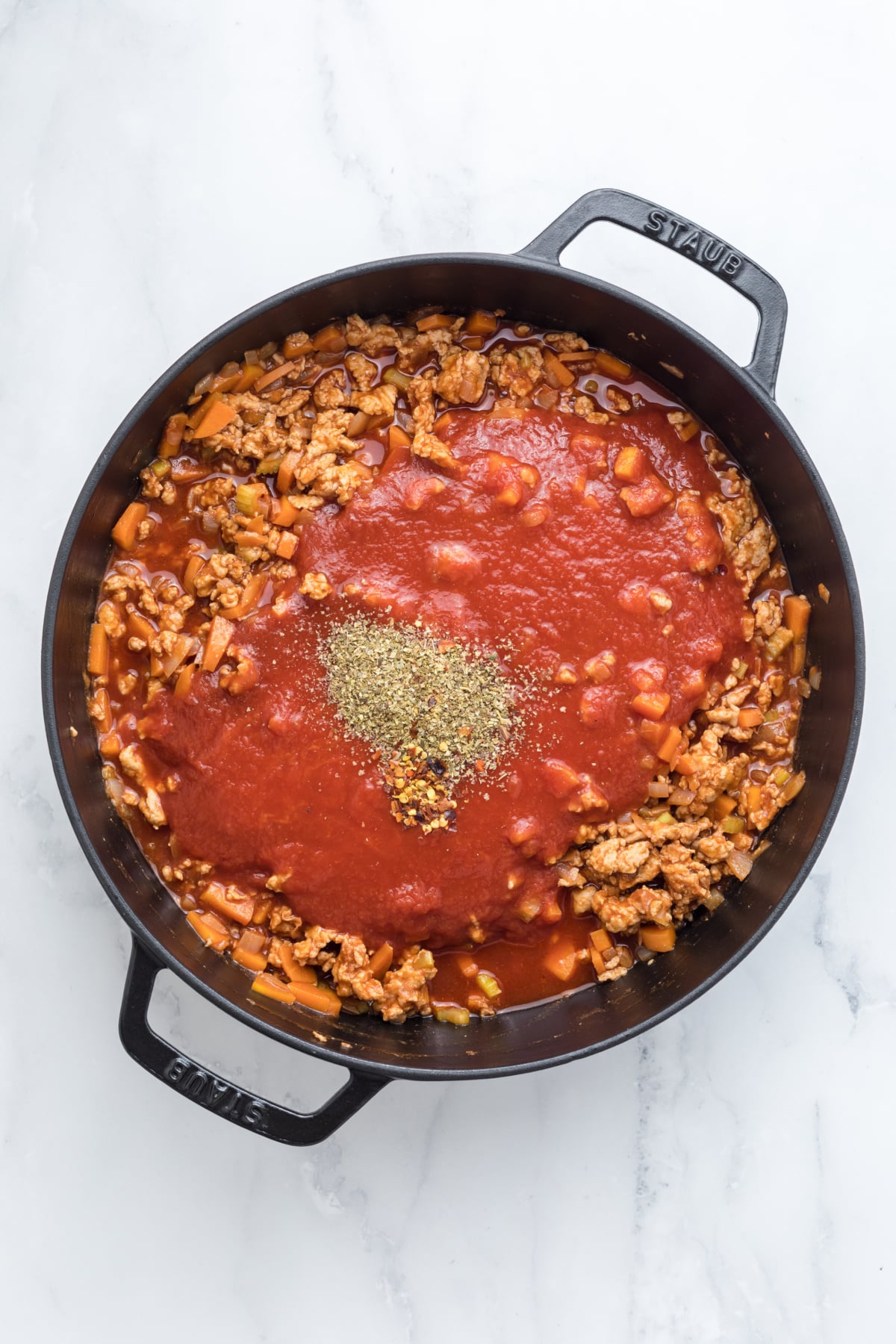 Tomato sauce and spices added to the skillet.