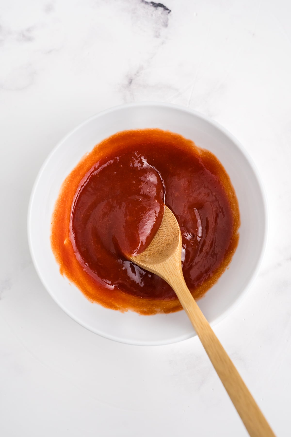 Chicken meatloaf sauce in a bowl with a wooden spoon. 