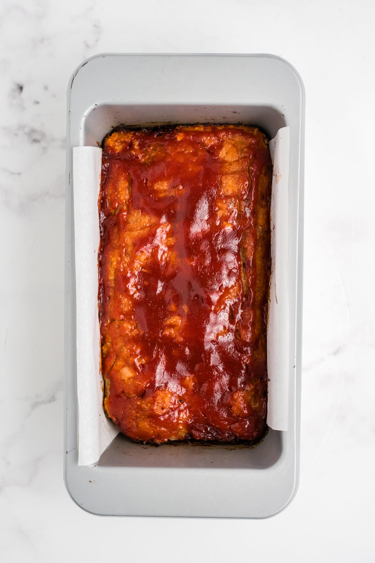 Ground chicken meatloaf with sauce added on top. 