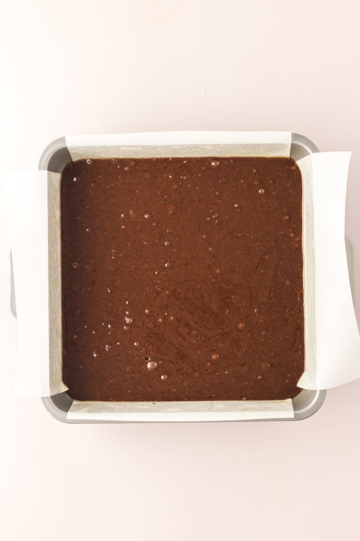 Brownie batter added to pan.