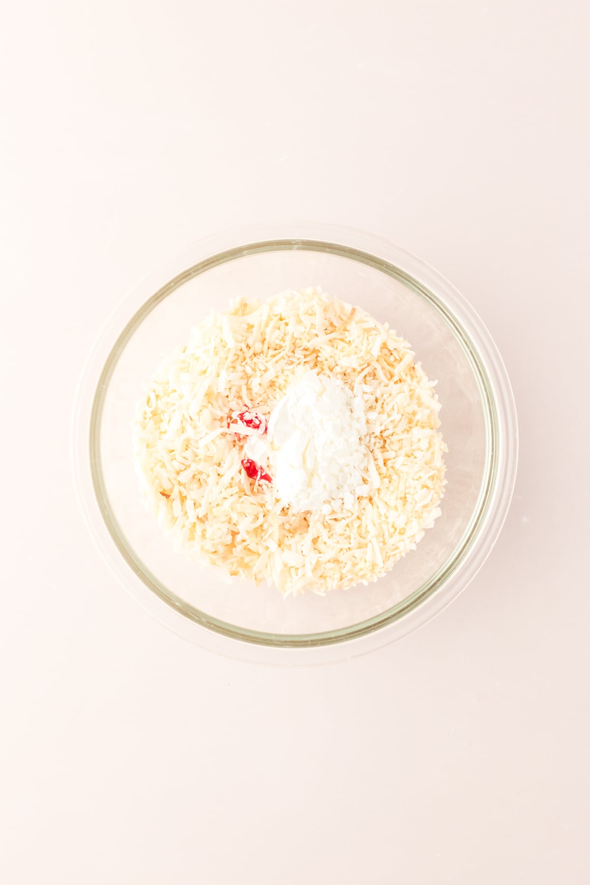 Coconut, cornstarch and food coloring in bowl.