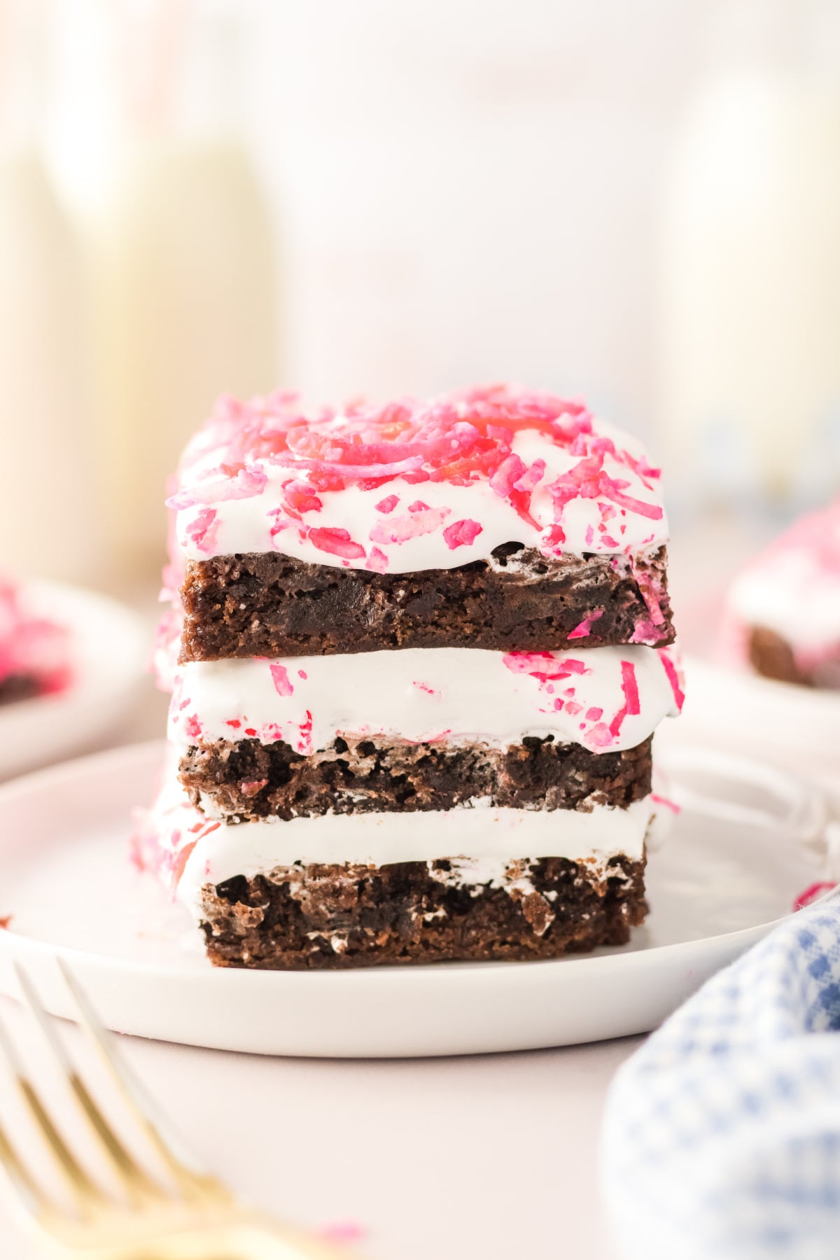 Three brownies stacked on top of each other on a plate