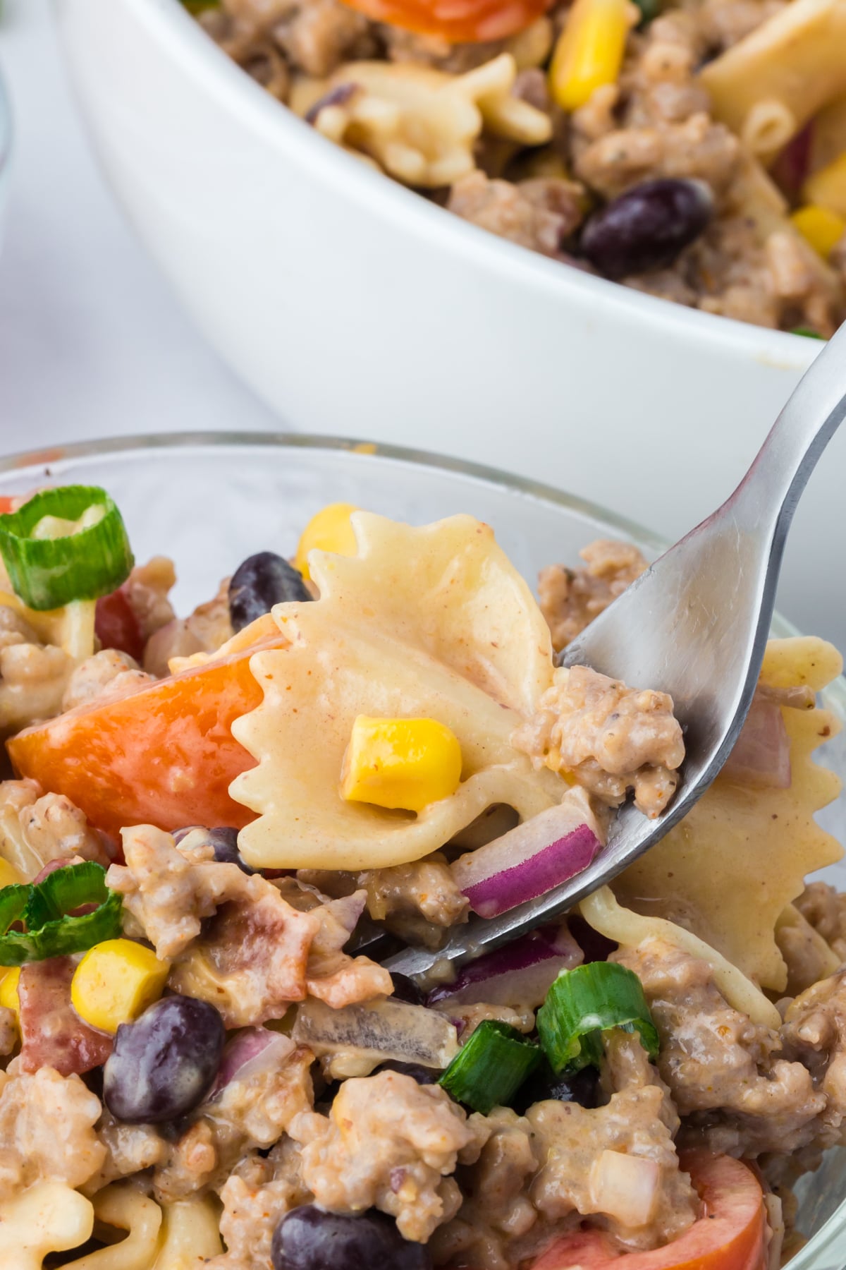 a forkful of salad being lifted out of bowl