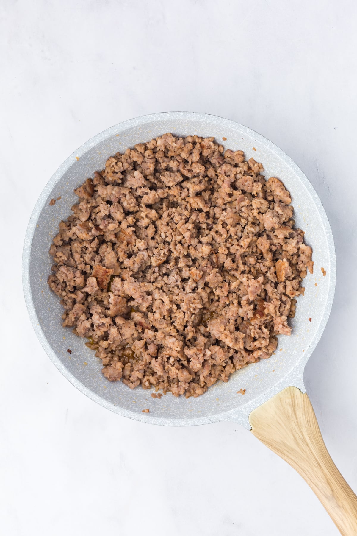 sausage in skillet cooking 