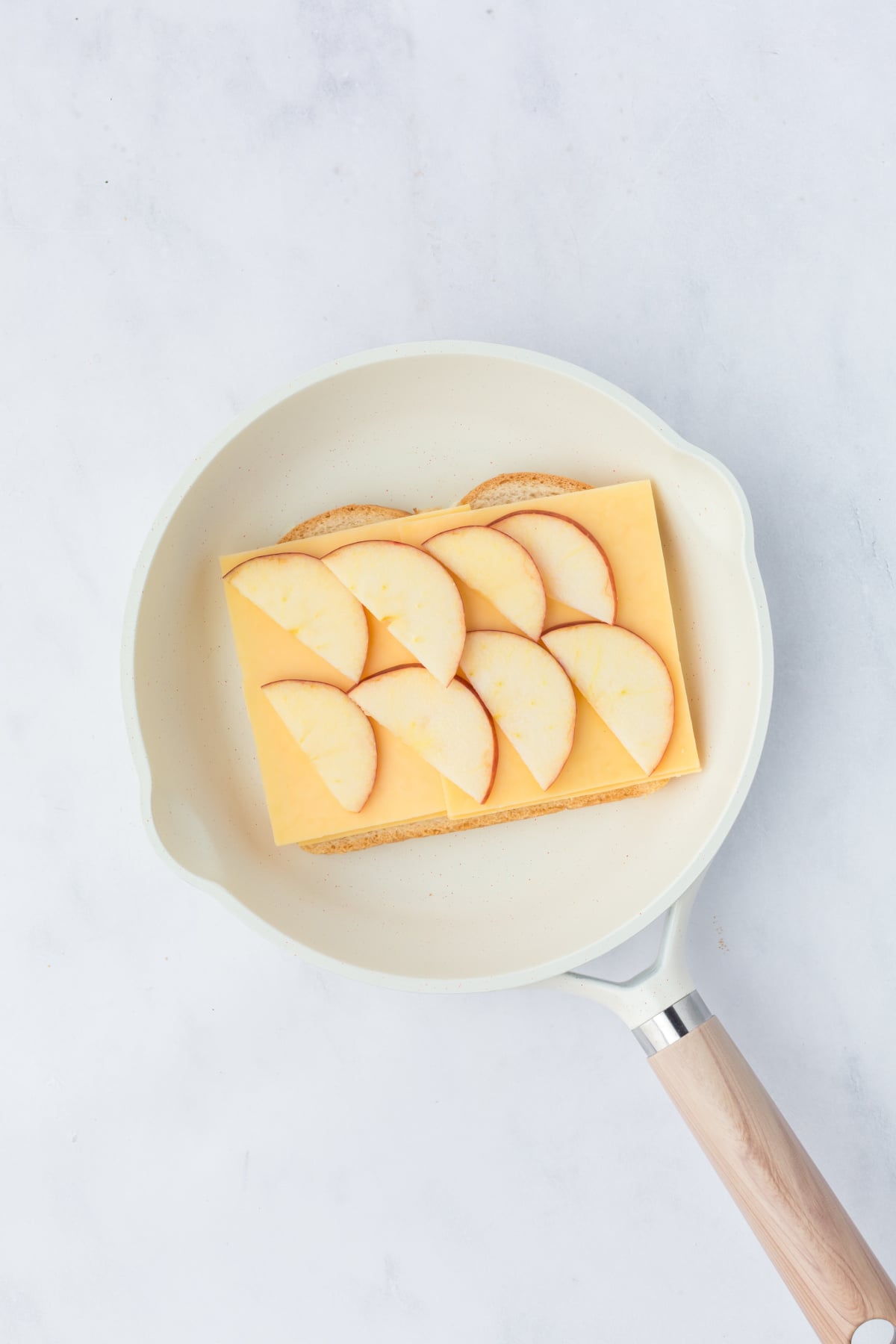 bread cheese and apple slices inside skillet