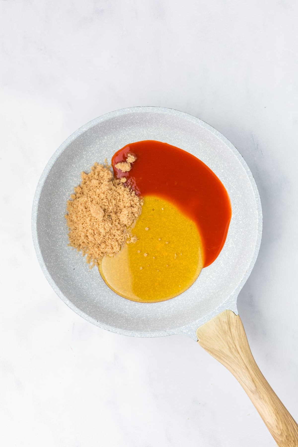 ingredients needed for hot honey sauce in a skillet