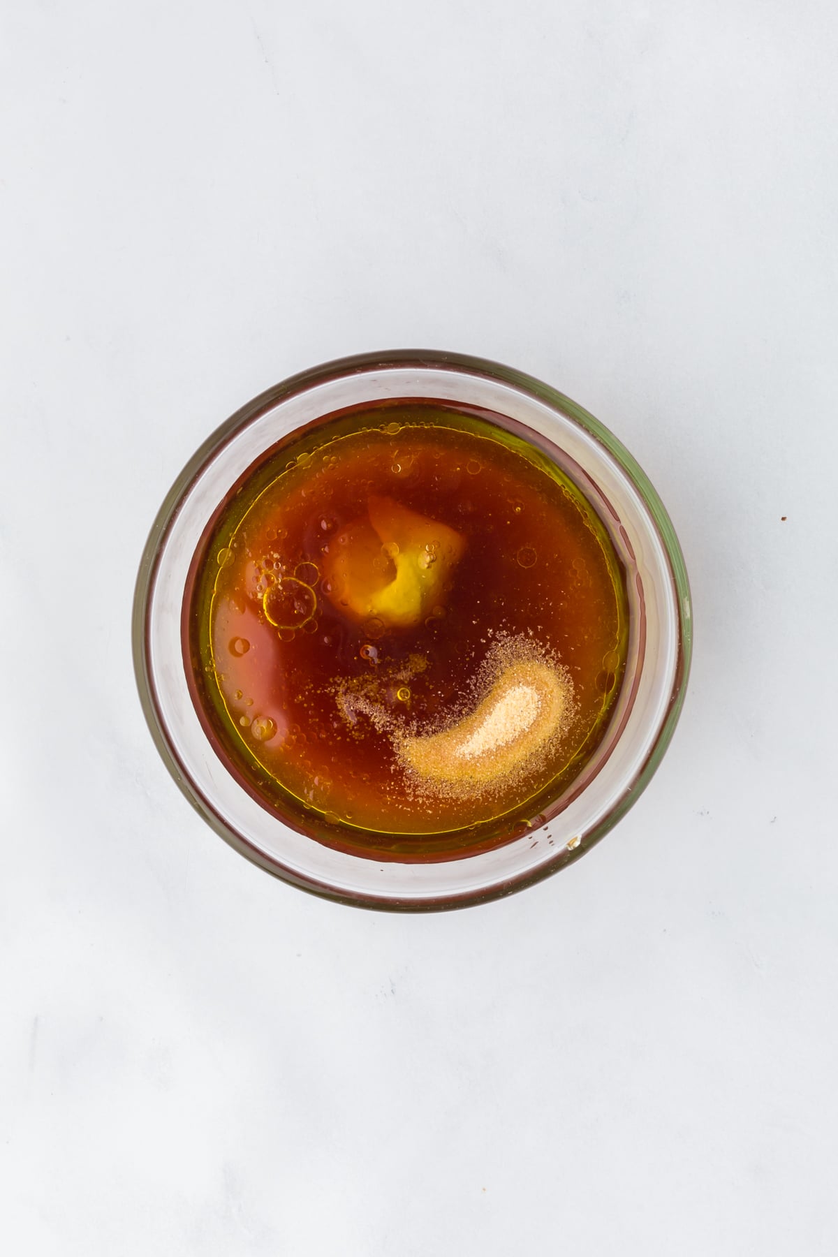 Red wine vinegar, hot honey, garlic powder, salt, lemon juice, Dijon mustard and olive oil in a mason jar. 