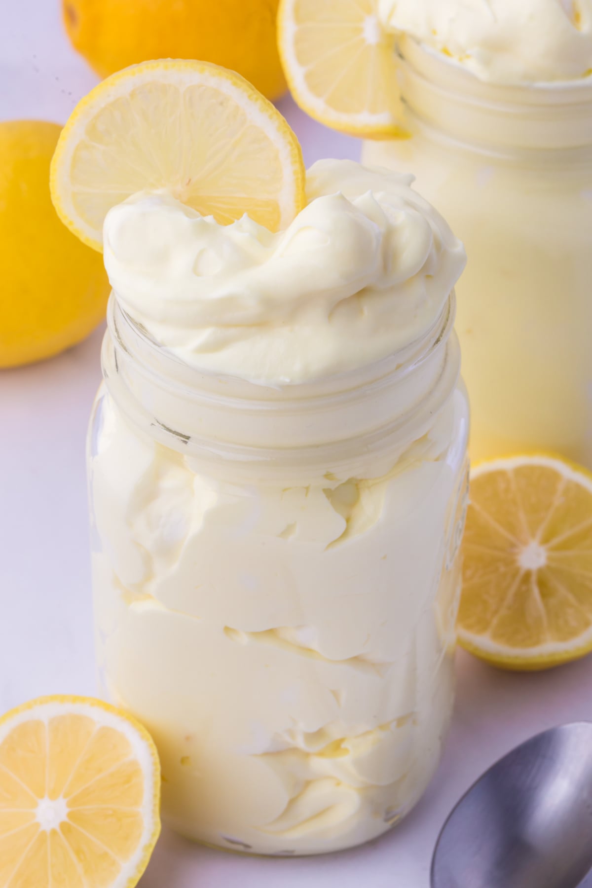 Serving lemon fluff in a mason jar as a light and refreshing dessert perfect for potlucks and summer gatherings