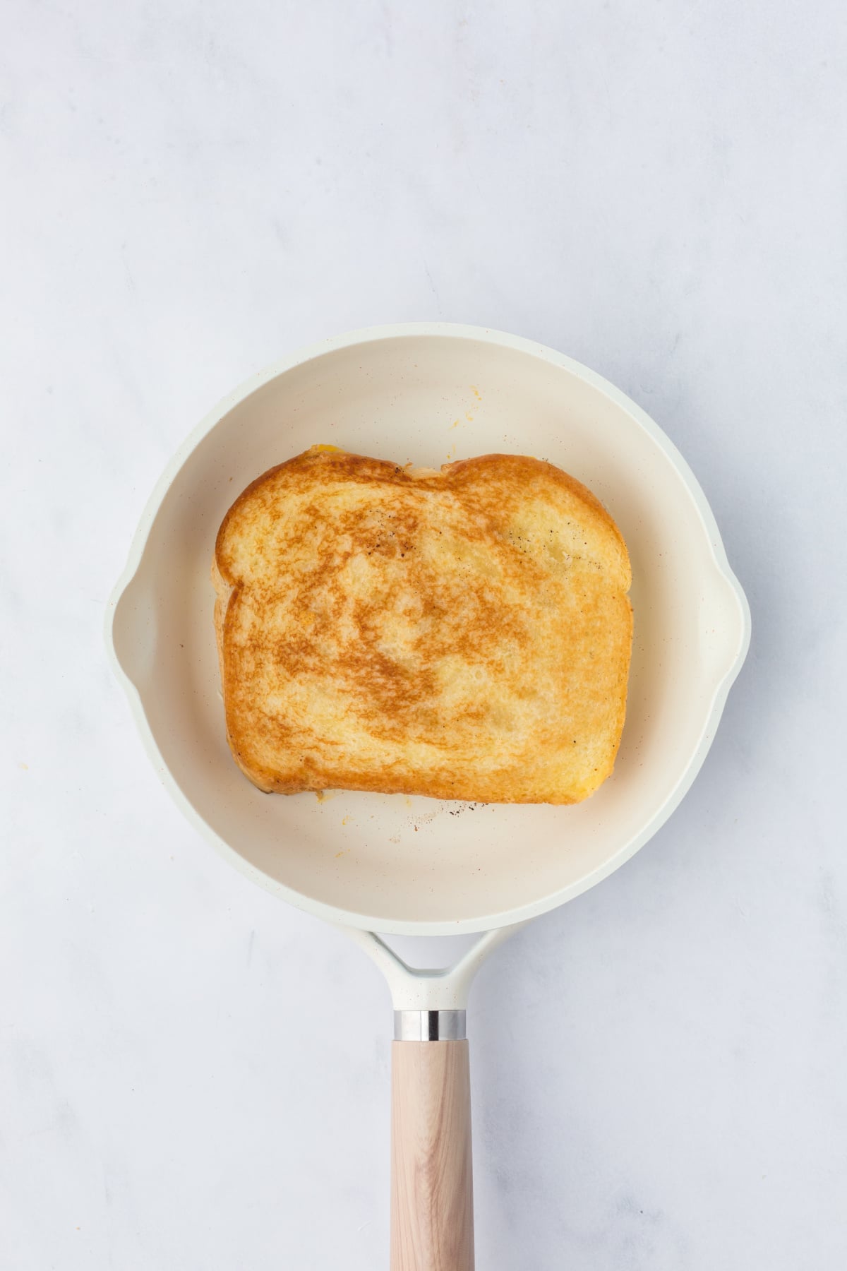 golden grilled mac and cheese sandwich cooking in skillet