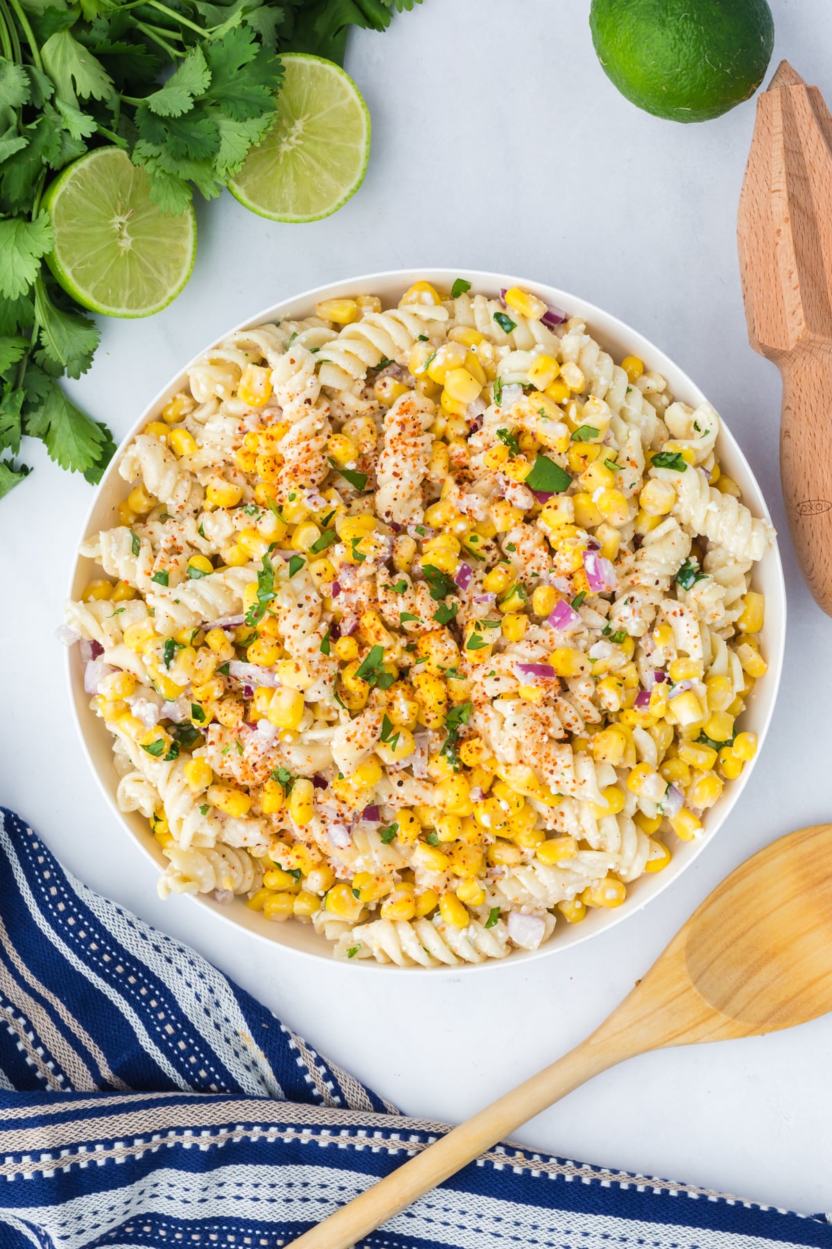elote pasta salad topped with tajin and cilantro before serving