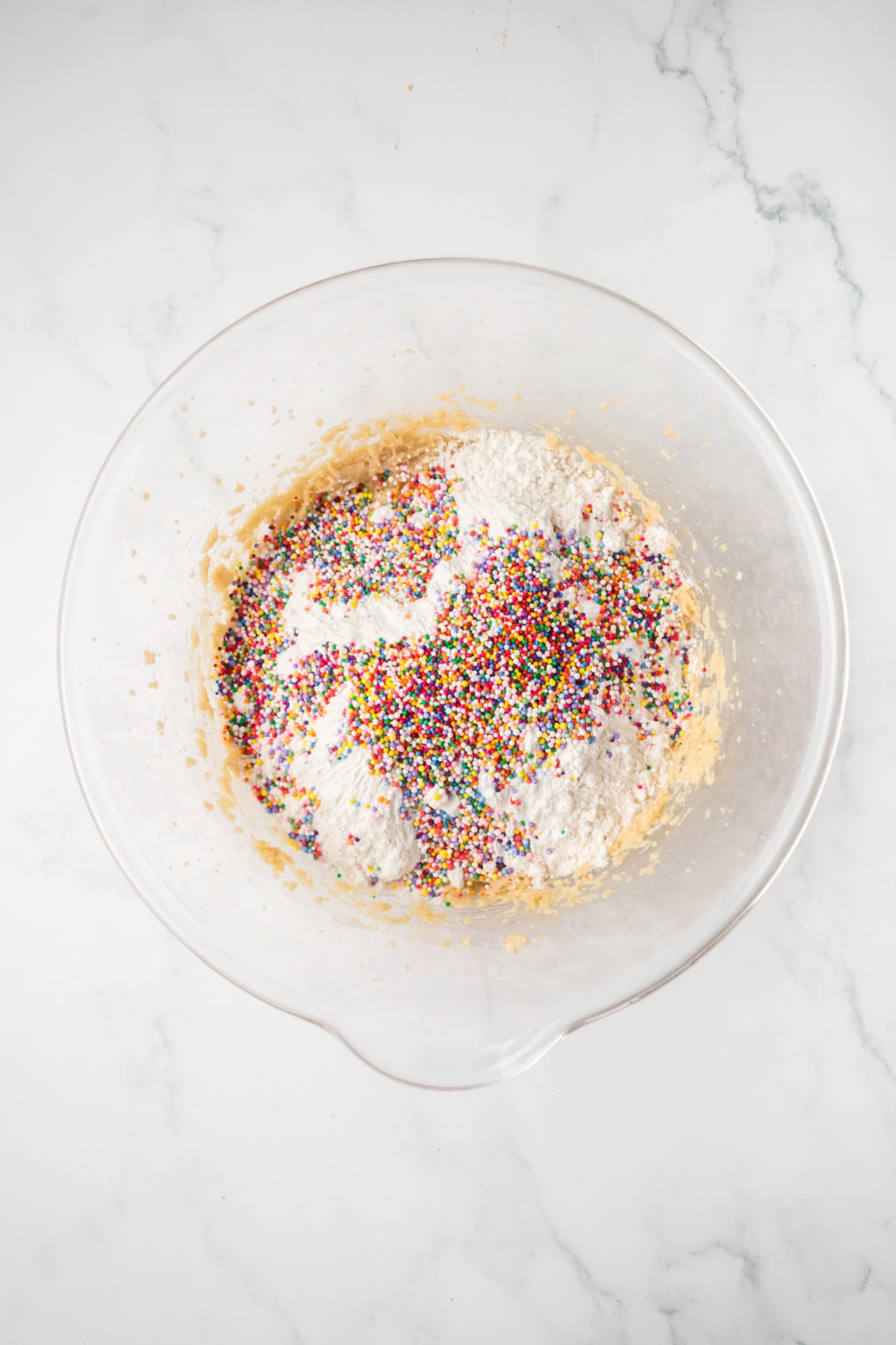 mixing dry ingredients into cookie dough for oreo bars in bowl