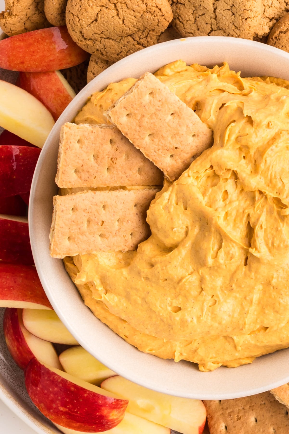 Three crackers dipped into the fluff with pumpkin puree. 