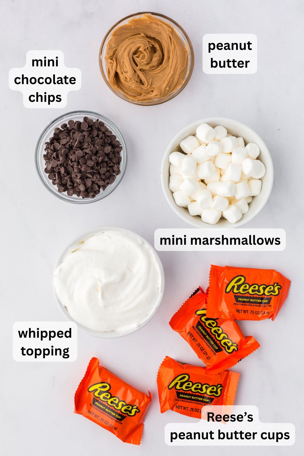 All the ingredients needed to make Reese's Fluff in bowls on a table