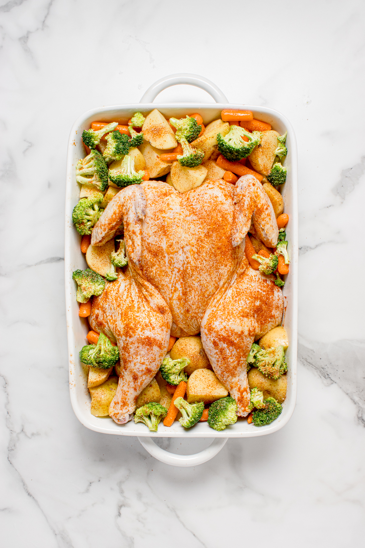 The veggies placed around the chicken.