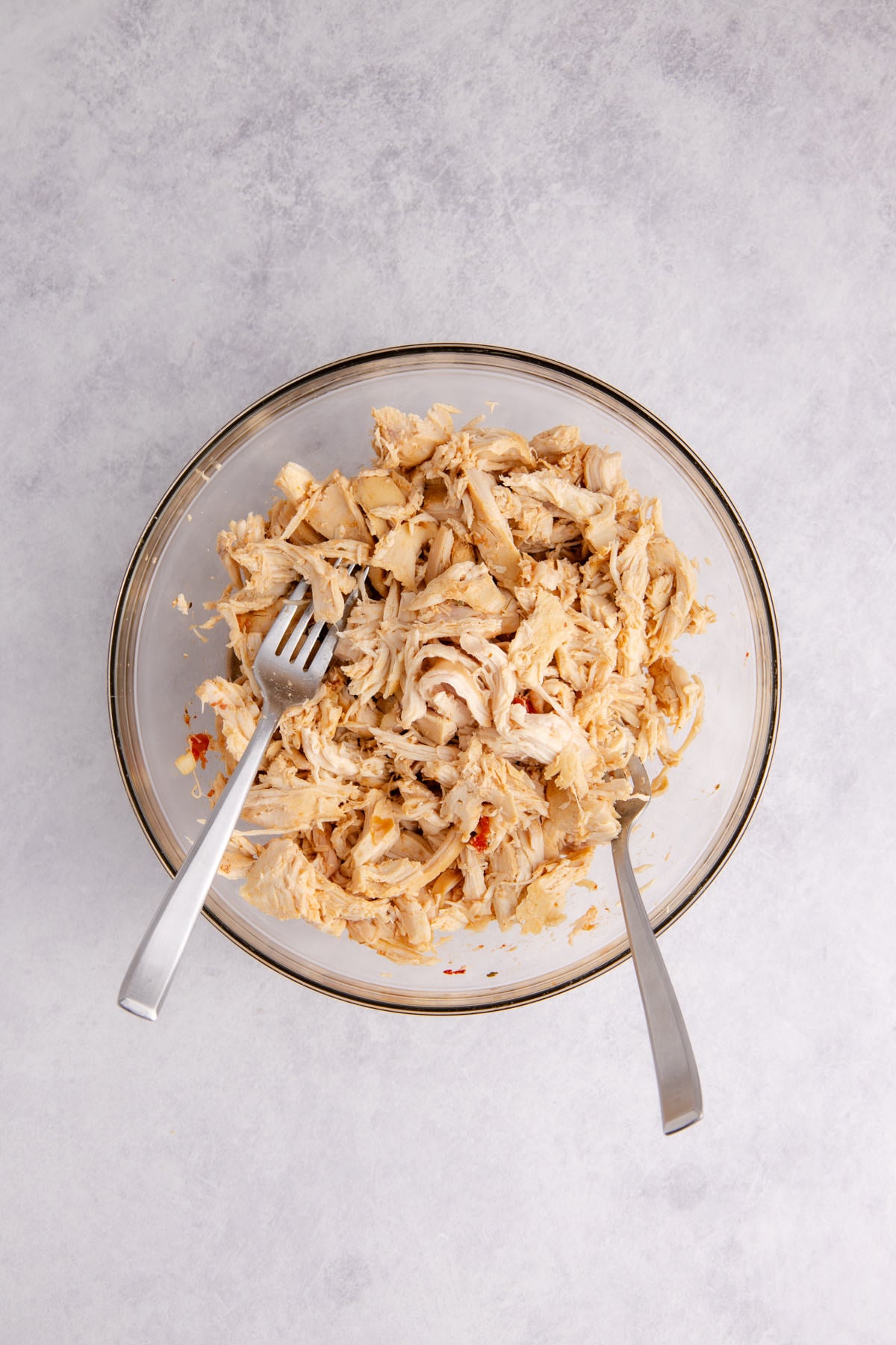 The chicken shredded in a bowl.