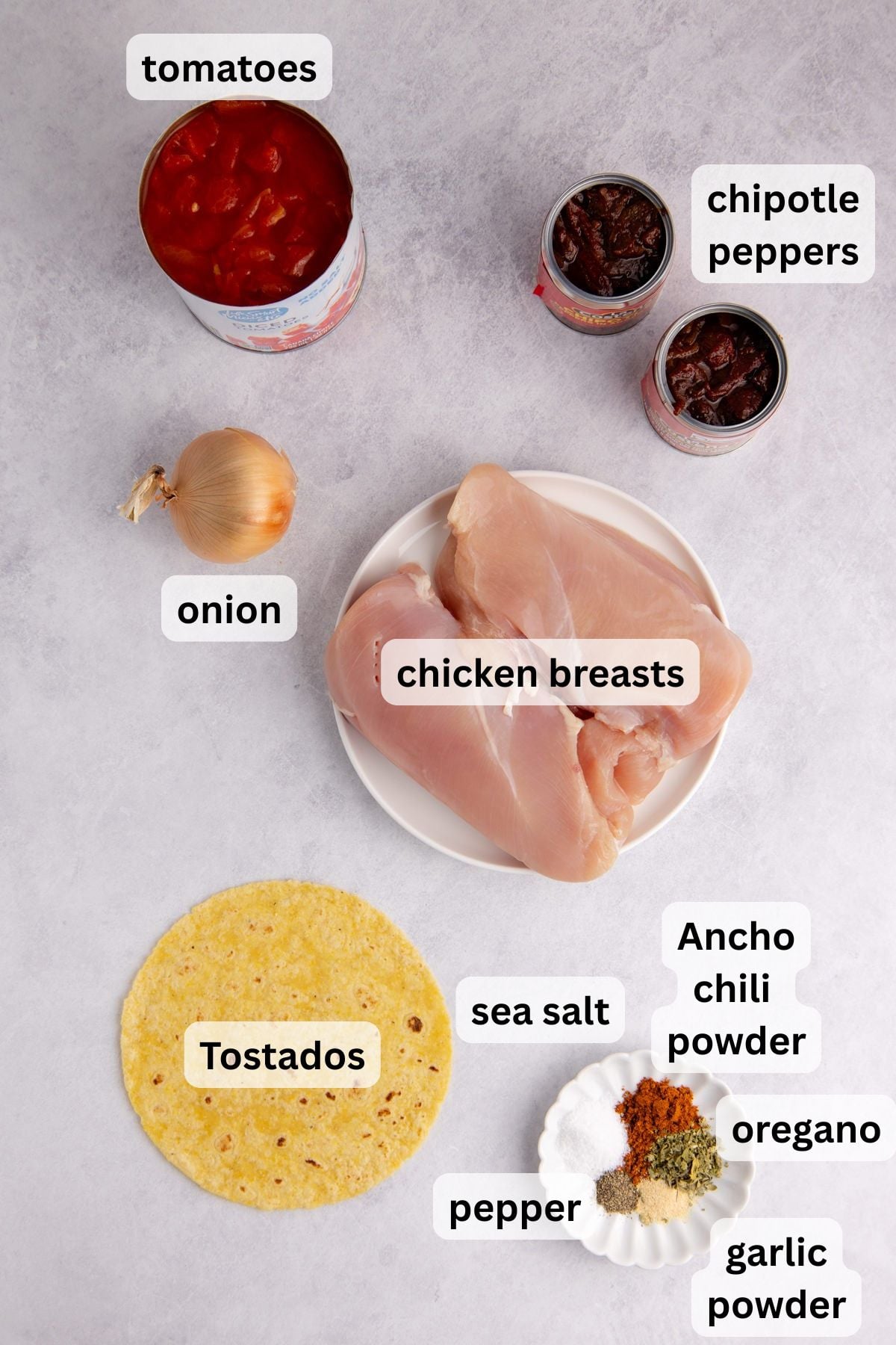 All the ingredients needed to make this chicken in bowls on a table.