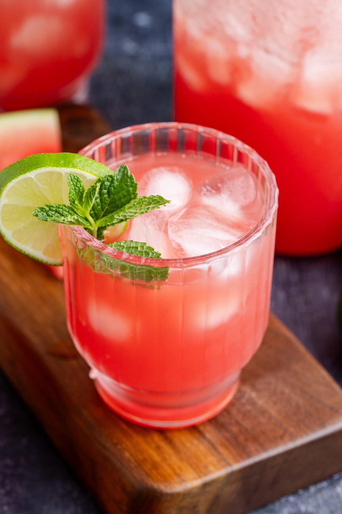 A glass of watermelon agua fresca on the table.