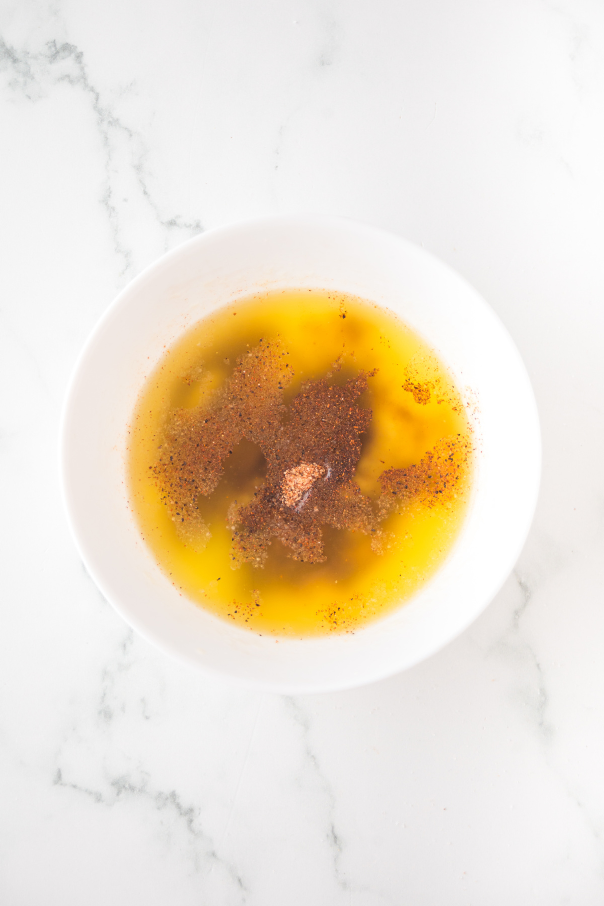 mixing melted butter and cajun seasoning for pretzels