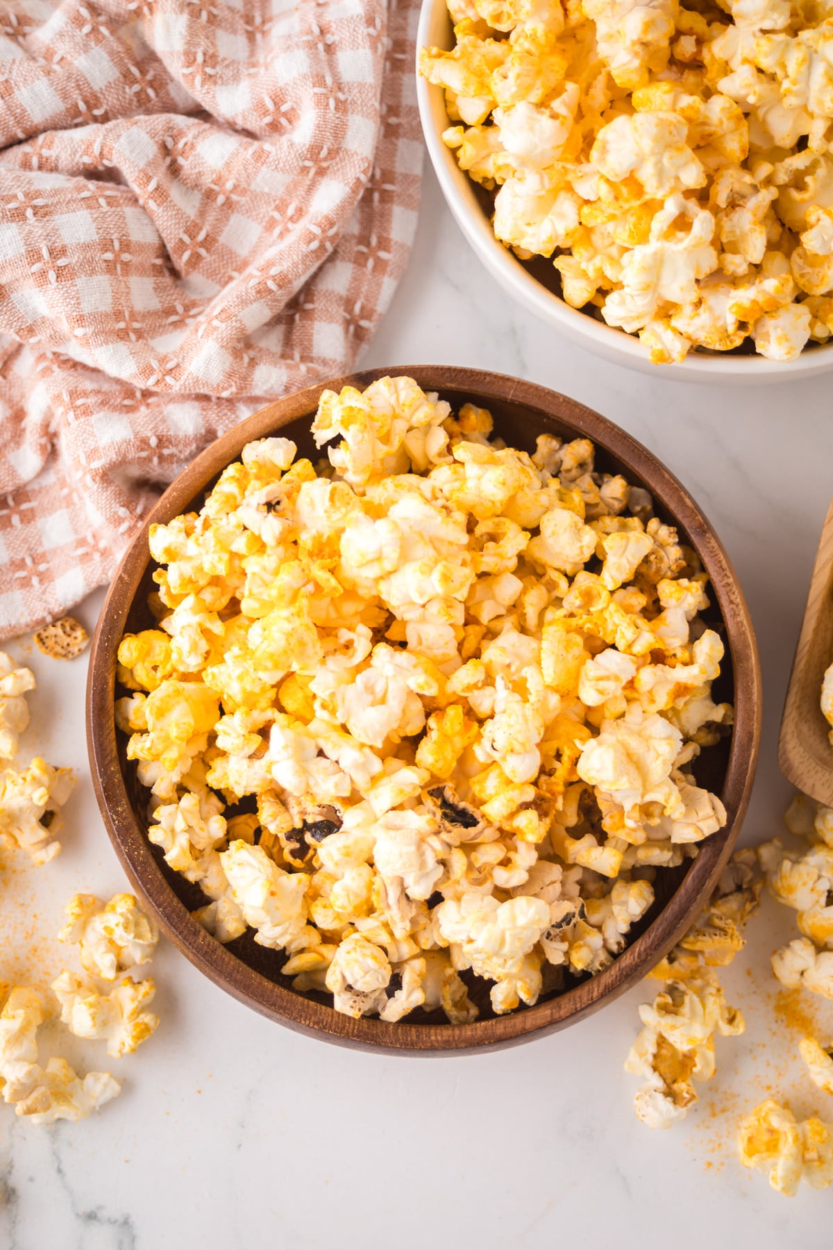 Popcorn in a wooden bowl on a table.