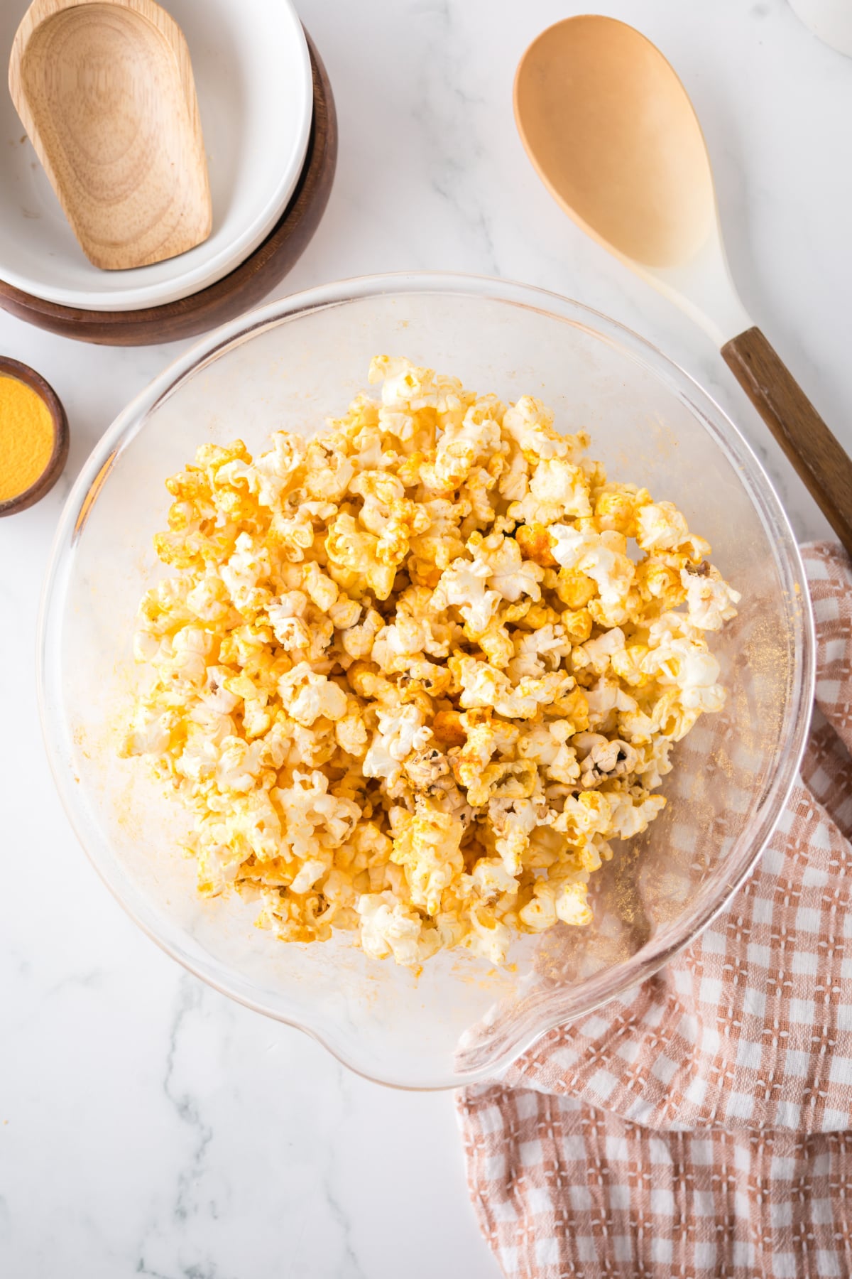 Popcorn in a bowl covered with cheese seasoning.