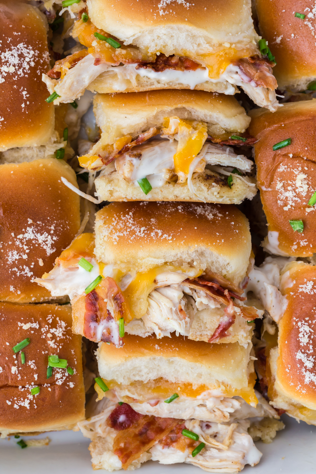 Sliders with chicken and bacon in them on a tray
