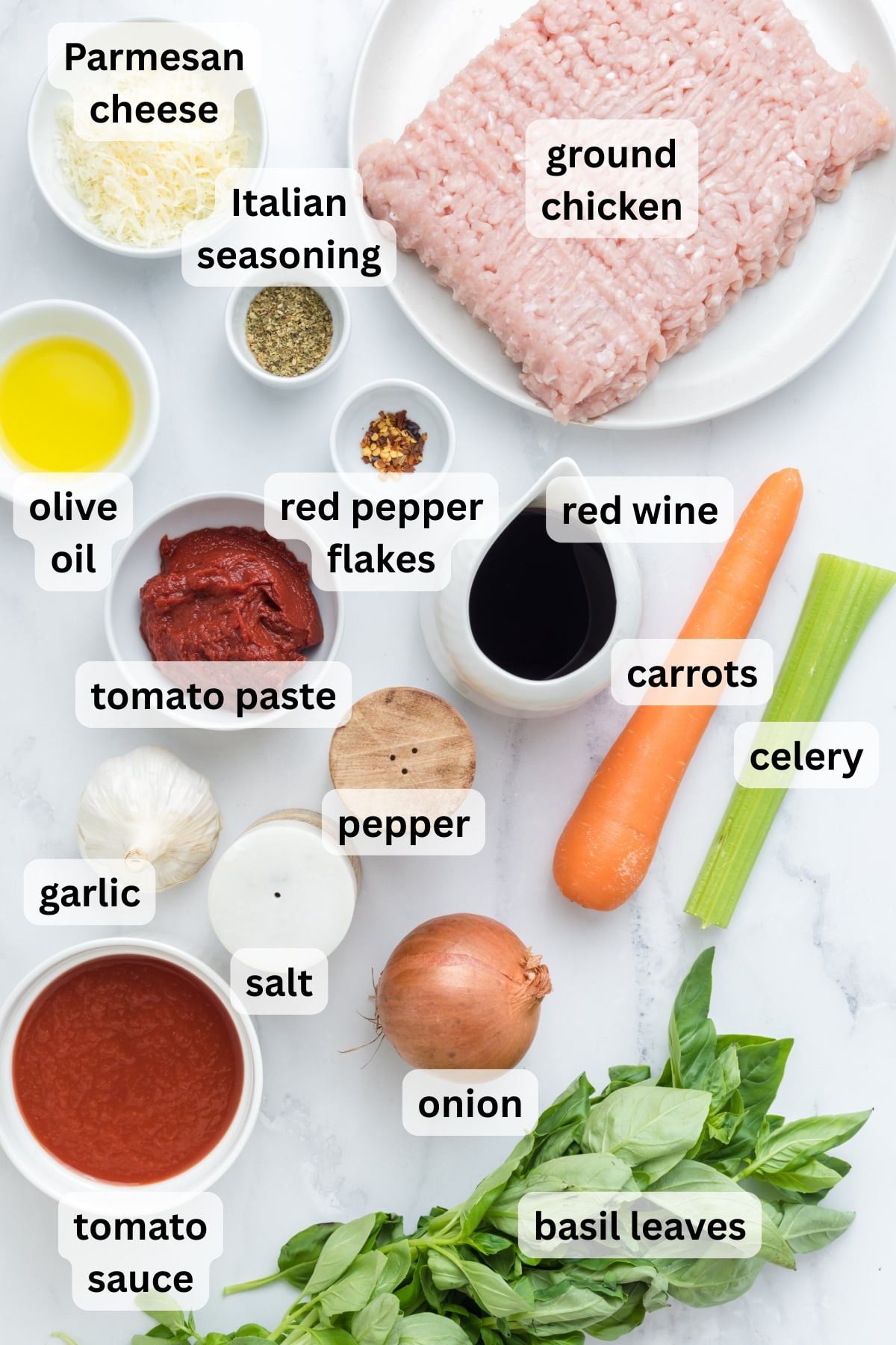 Ingredients to make this bolognese with ground chicken in a table.