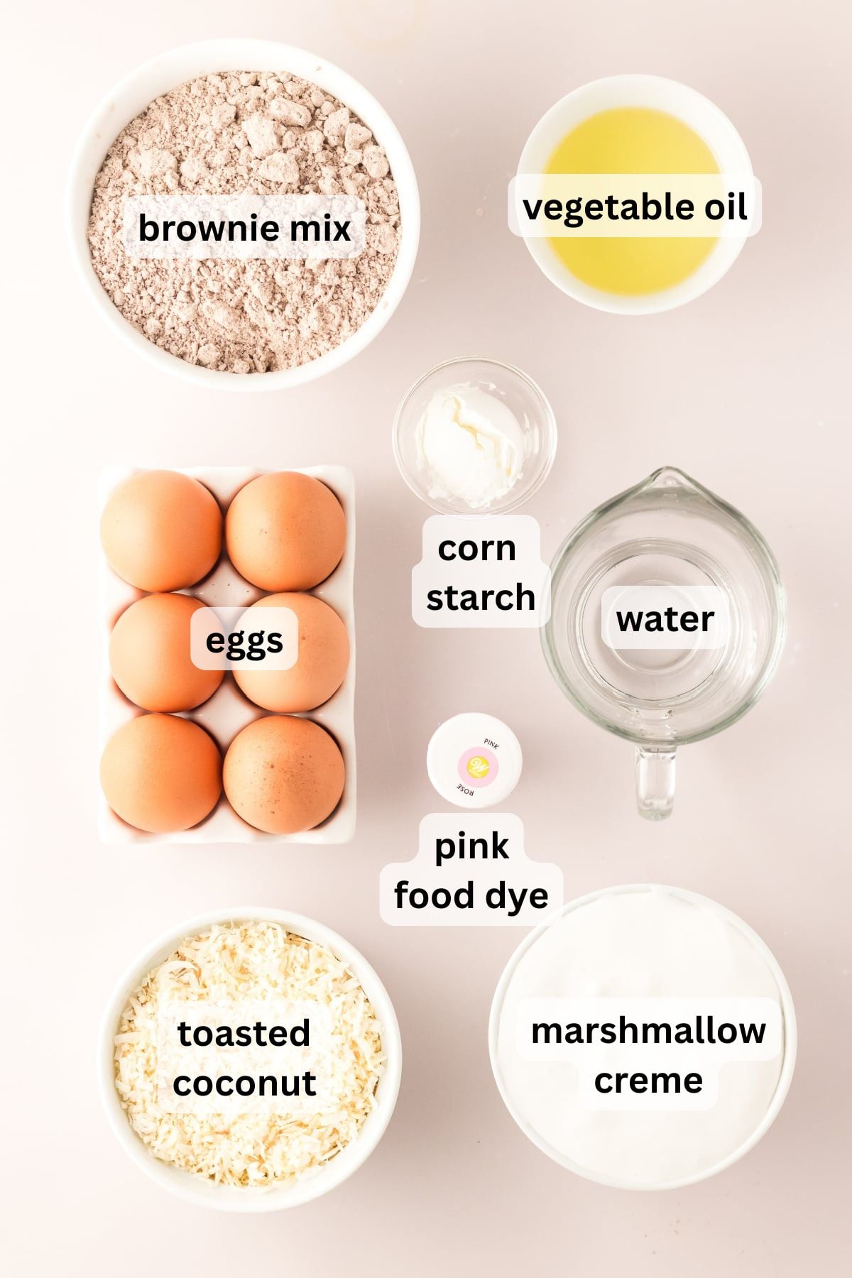 All the ingredients needed to make Coconut Brownies in bowls on a table