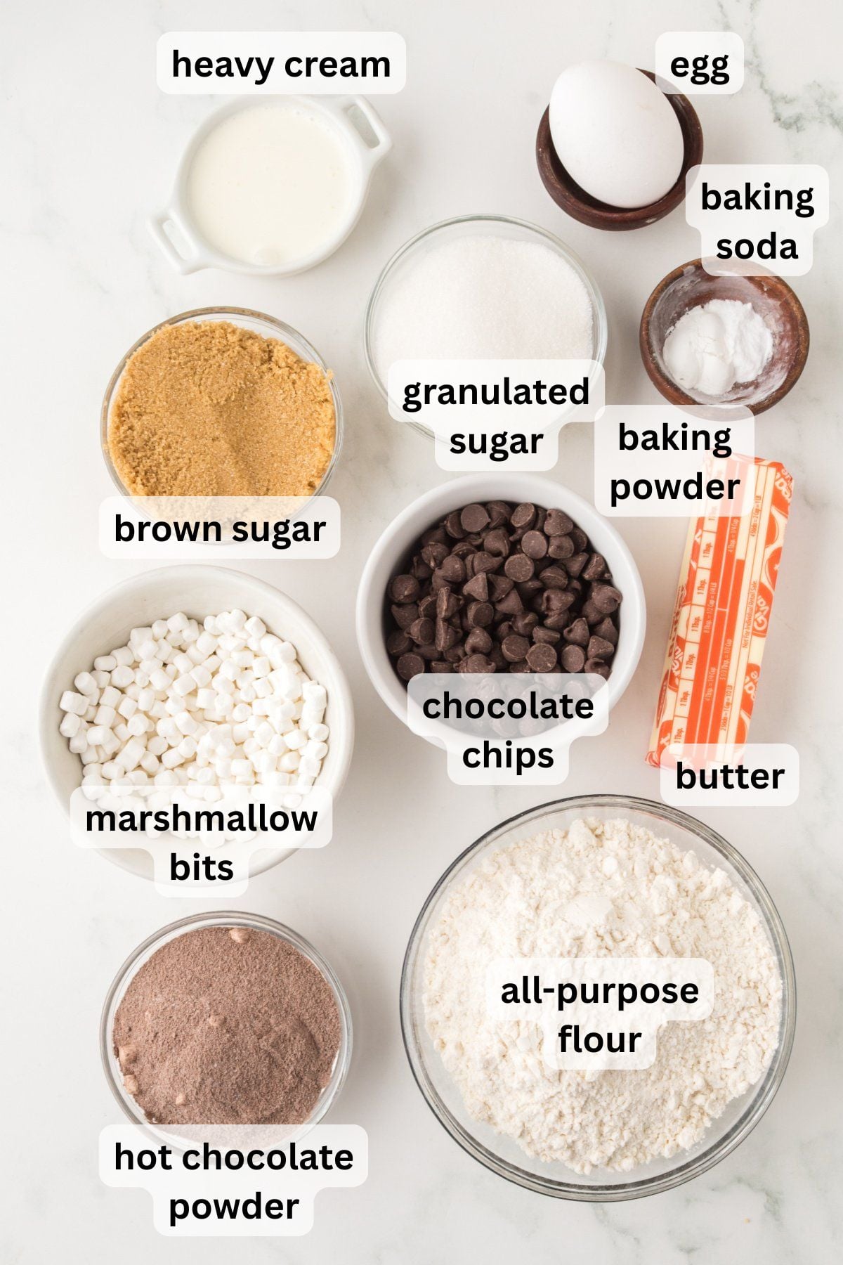 All the ingredients needed to make Hot Chocolate Cookies in bowls on a table.