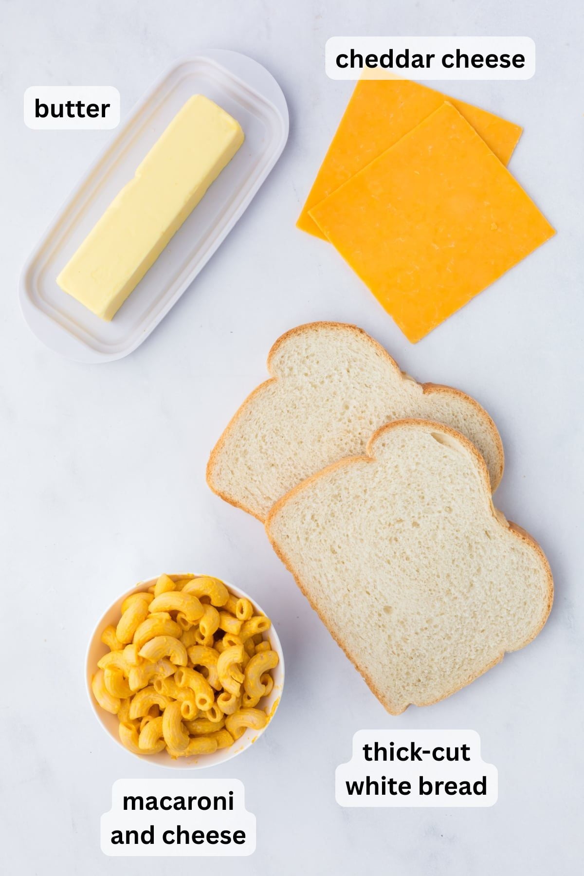 All the ingredients needed to make mac and cheese grilled cheese on a table