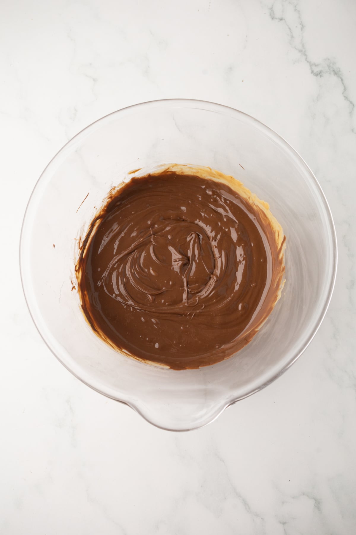 melting chocolate and peanut butter in a microwave safe bowl for muddy buddies
