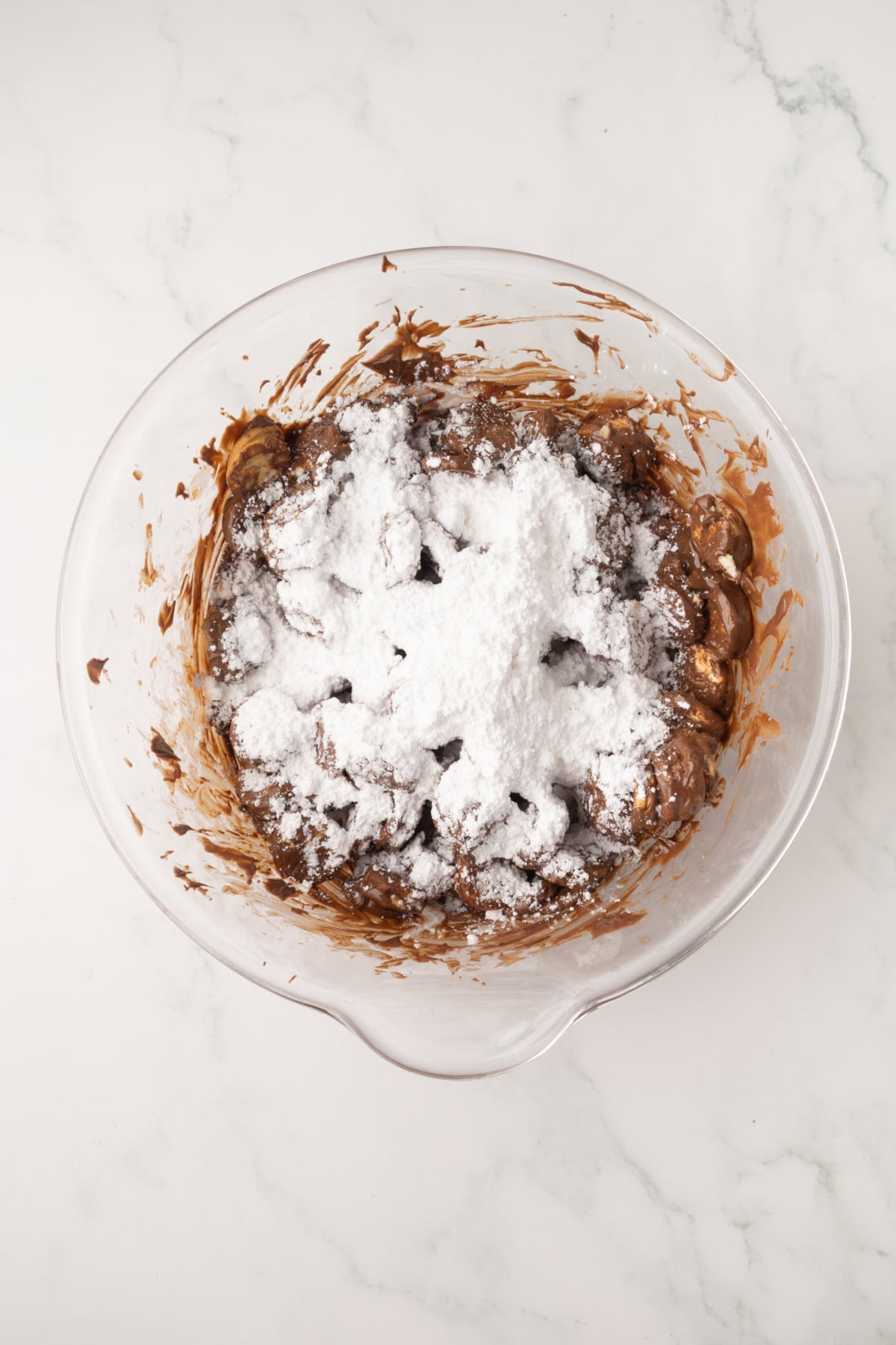 adding powdered sugar to chocolate coated ritz crackers