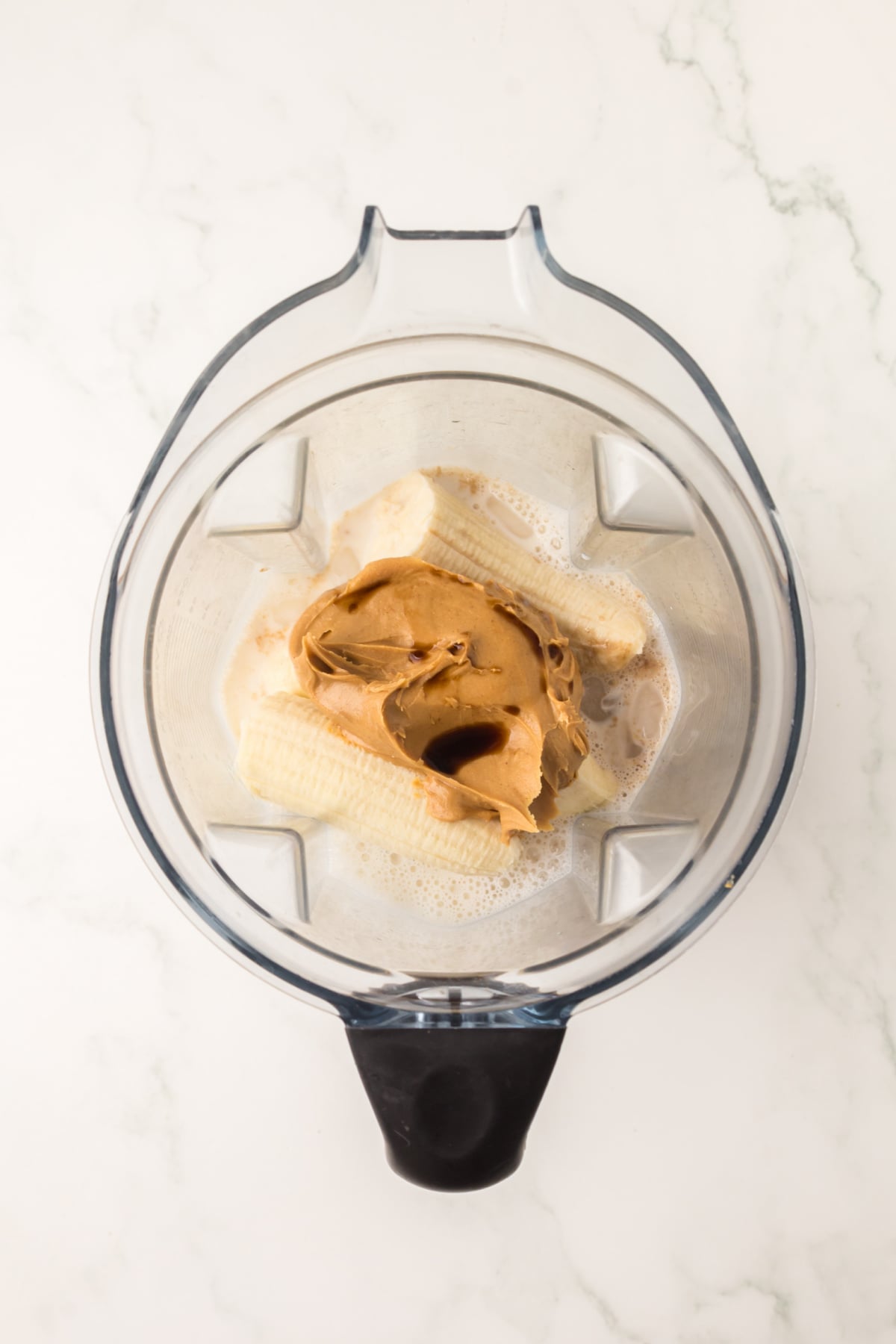 Ripe bananas, Creamy peanut butter. Vanilla extract, Whole milk in blender.