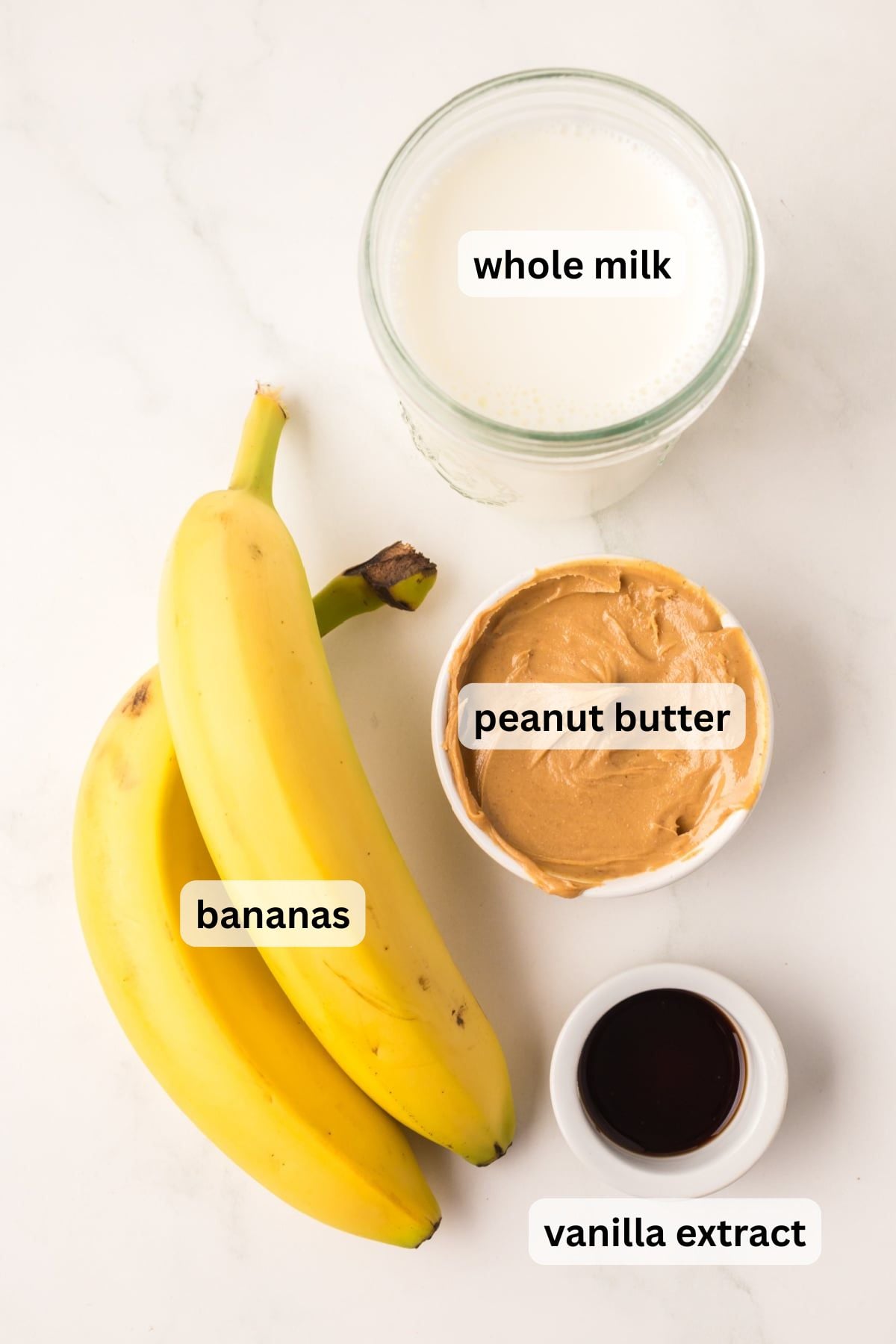 All the ingredients needed to make Banana Peanut Butter Smoothie in bowls on a table.