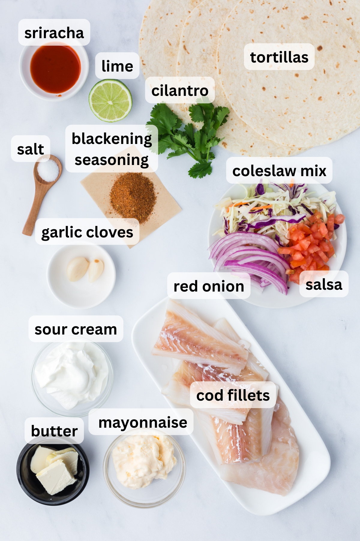 Ingredients to make these blackened fish tacos on a table.