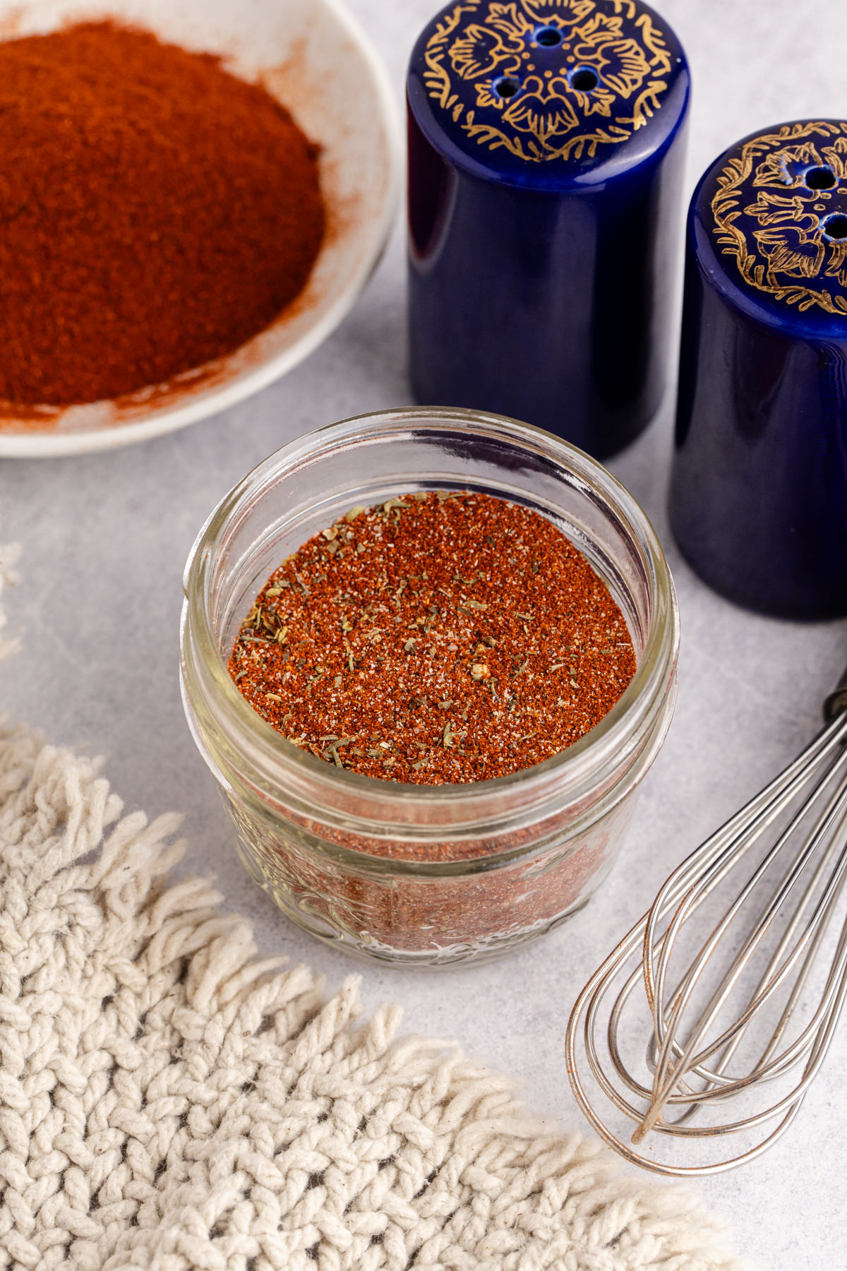 Blackening seasoning in a jar opn a table.