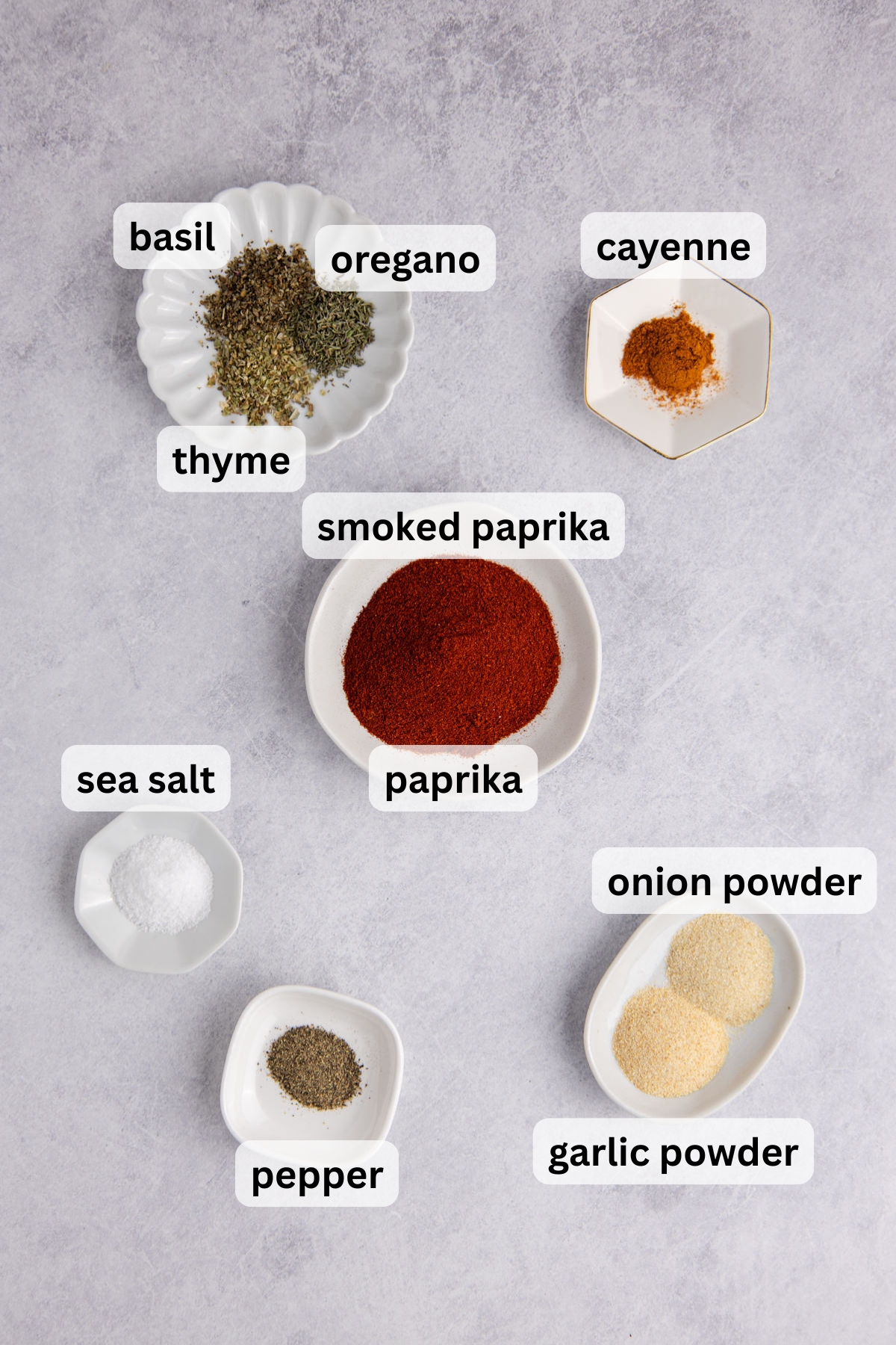 Ingredients to make homemade blackening seasoning in bowls on a table.