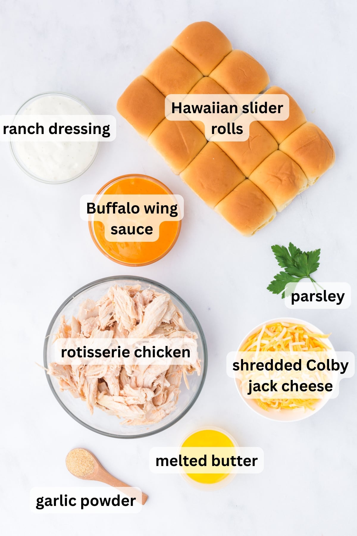 All the ingredients needed to make Buffalo Chicken Sliders on a table