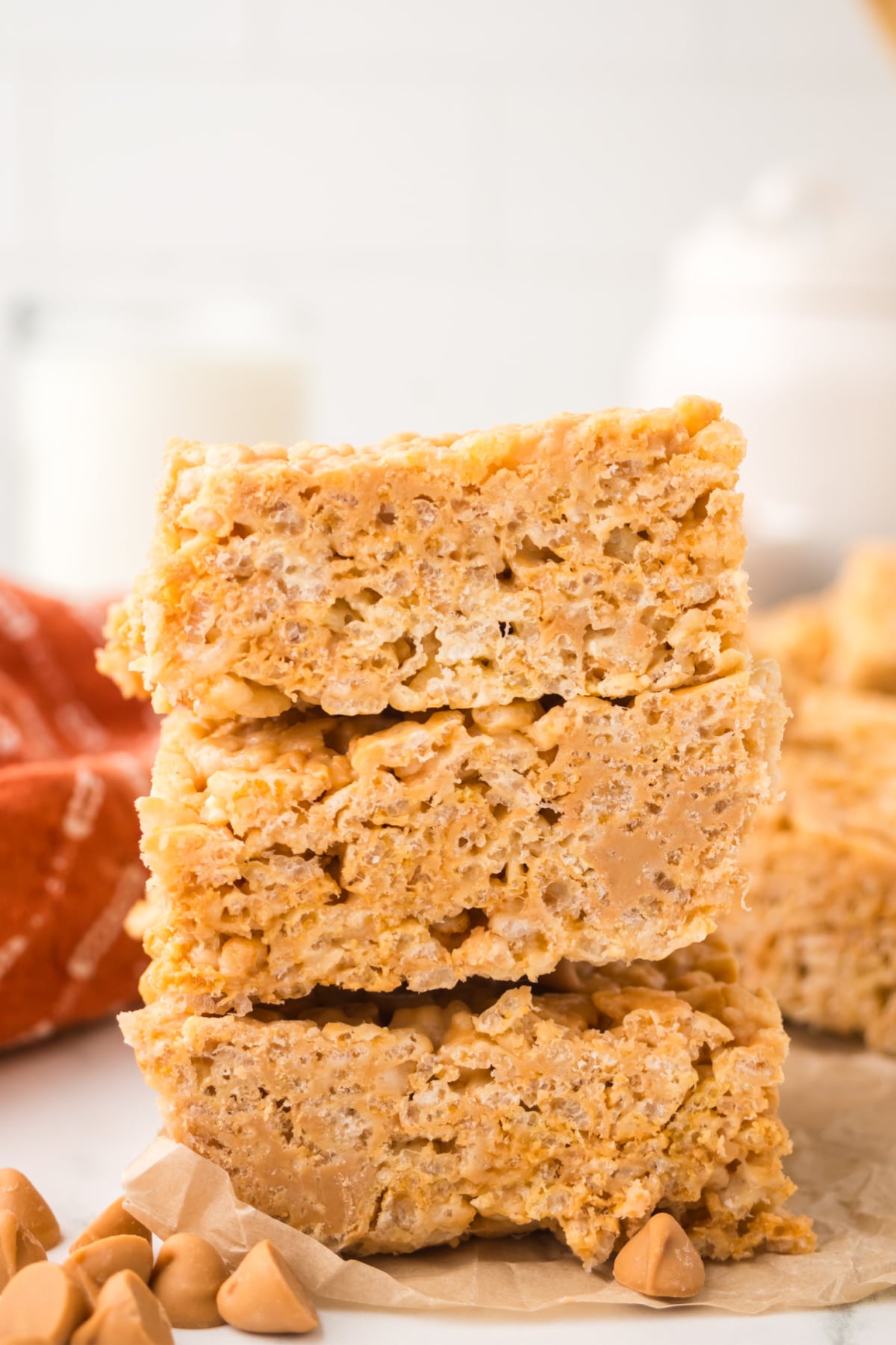butterscotch rice krispie treats stacked on pan full of gooey marshmallow dessert squares