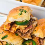 Cowboy sliders in serving dish with one on top.