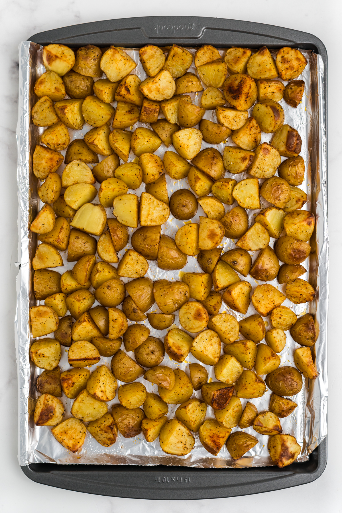 baked potatoes on a foil lined baking sheet