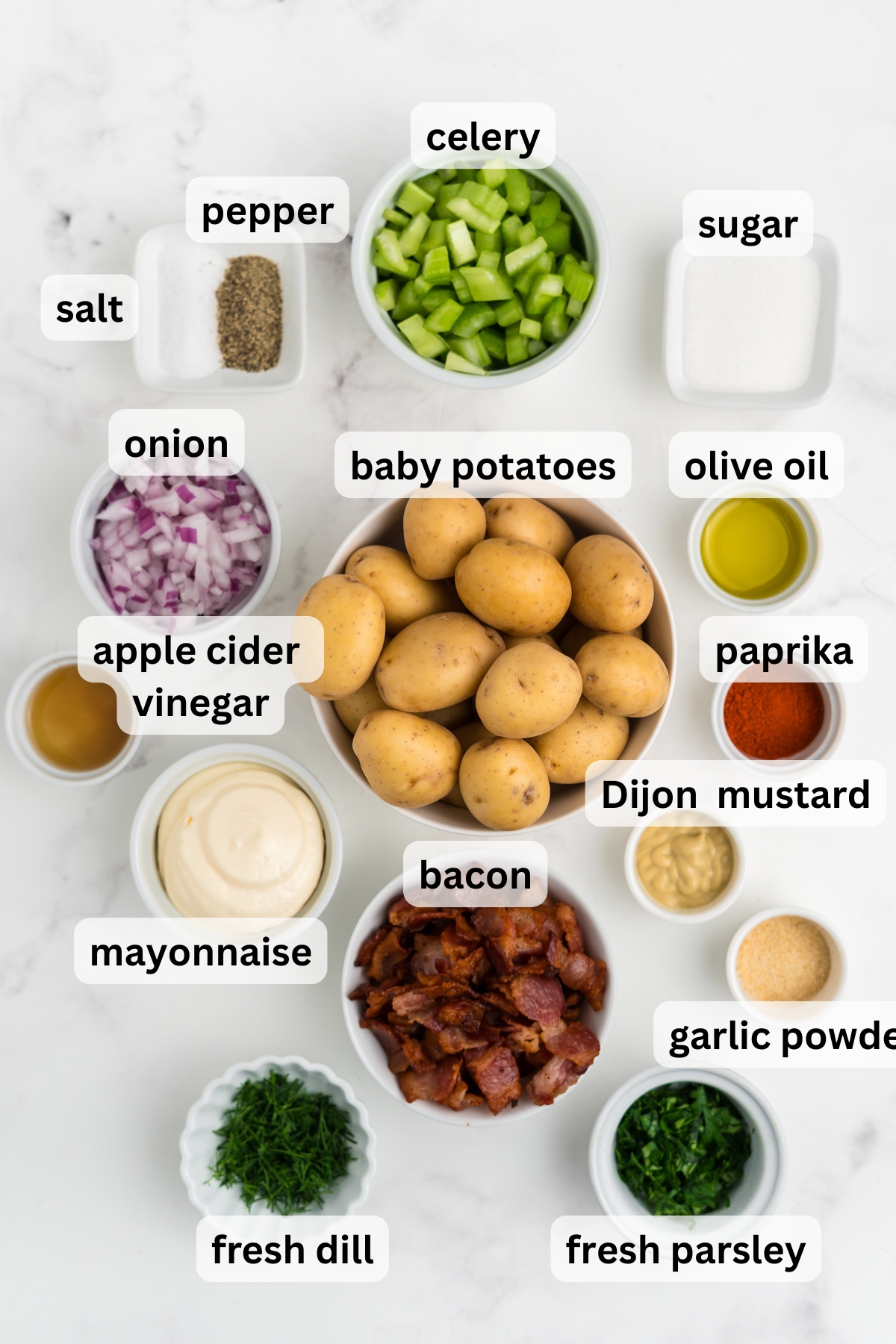 All of the ingredients needed to make Crispy Potato Salad in bowls on a table.
