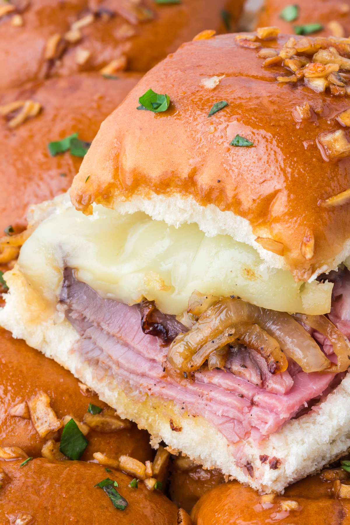 A slider on top of the dish full of sliders