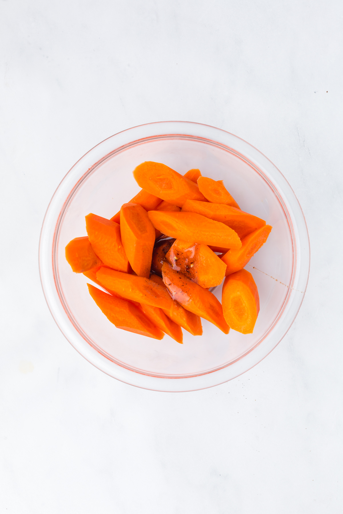 Sliced carrots added to the hot honey mixture ready to be stirred
