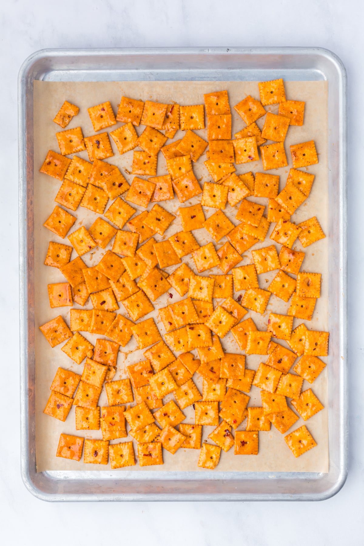 crackers spread evenly in one layer on baking sheet.