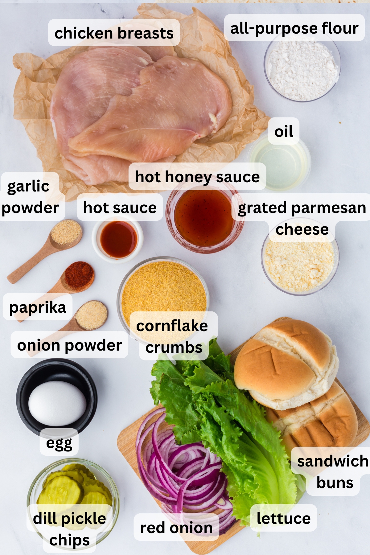 All of the ingredients needed to make a hot honey chicken sandwich in bowls on a table.
