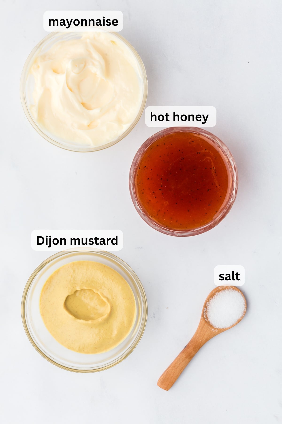 All of the ingredients needed to make Hot Honey Mustard in bowls on a table
