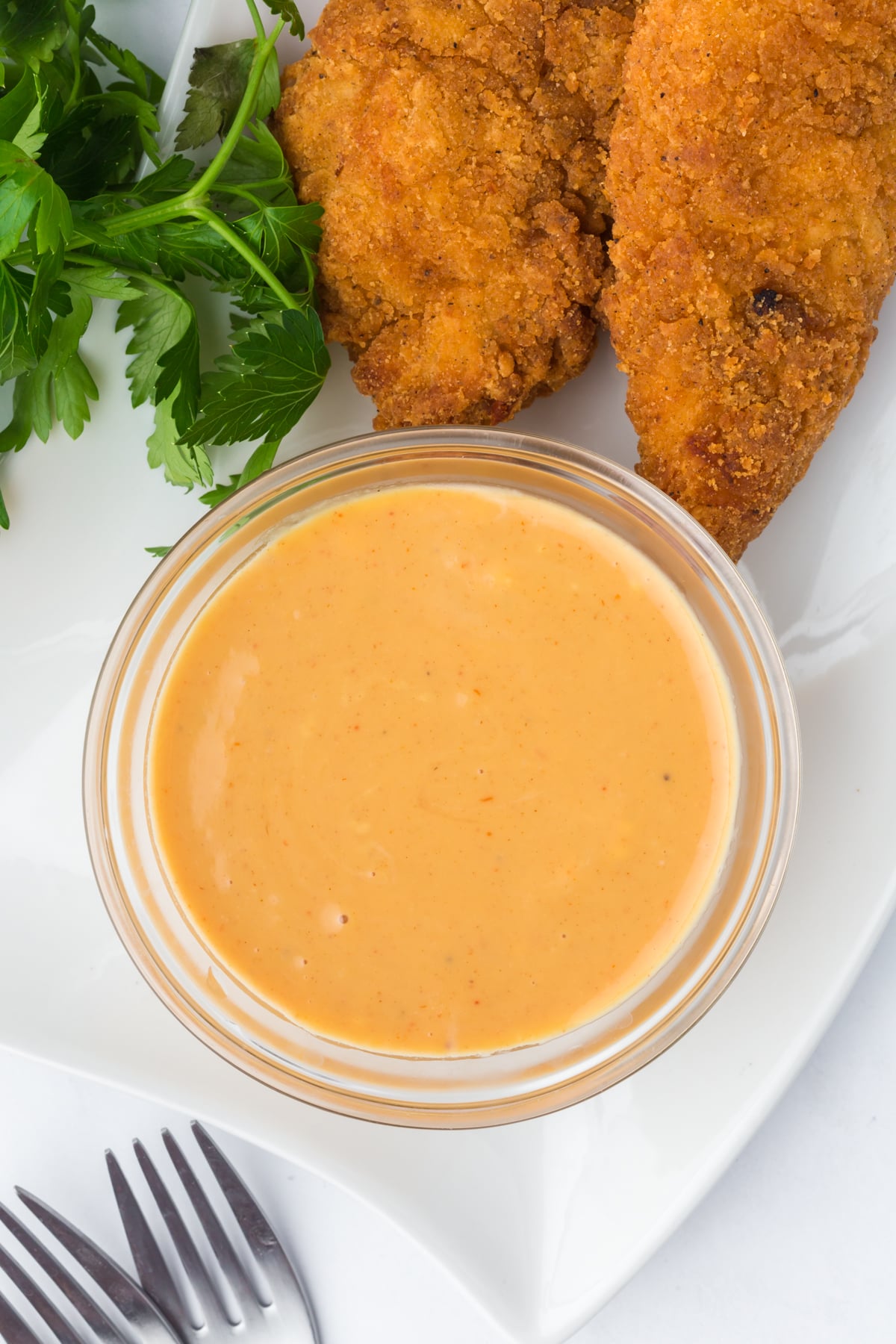 this hot honey mustard recipe whisked in a bowl beside chicken tenders